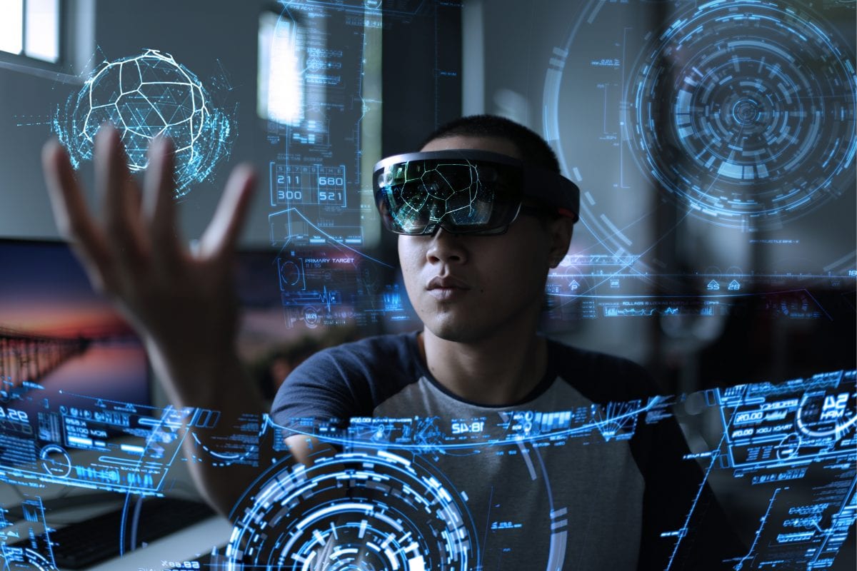 man wearing hololens goggles to experience mixed reality immersive content